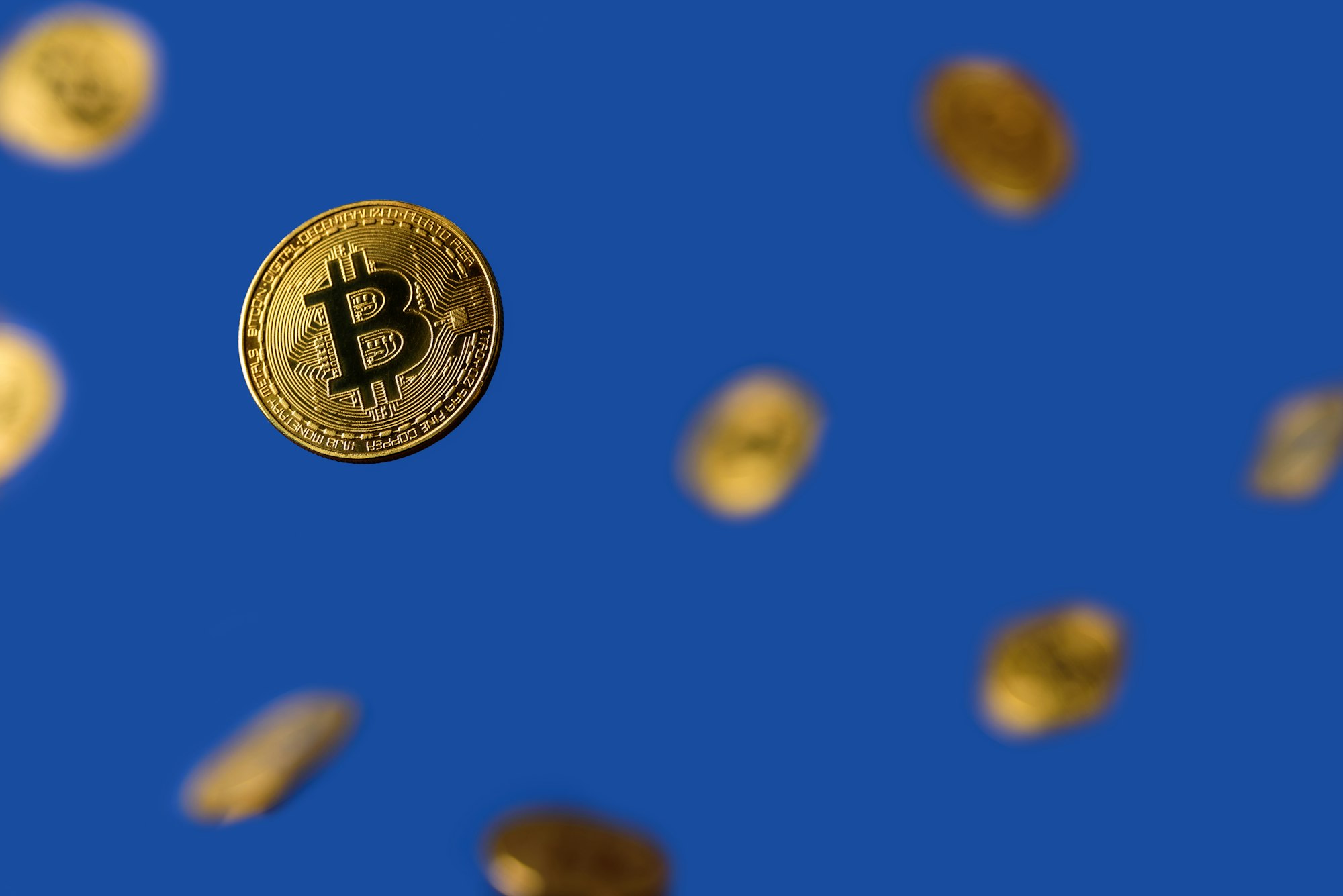 Bitcoins levitation on blue