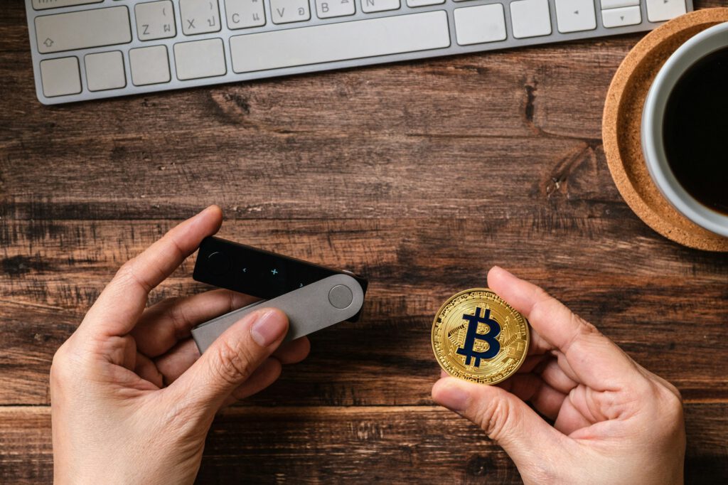 hand-holding-hardware-wallet-and-transfer-bitcoin-and-ethereum-crypto-currency-to-wallet-for-safety